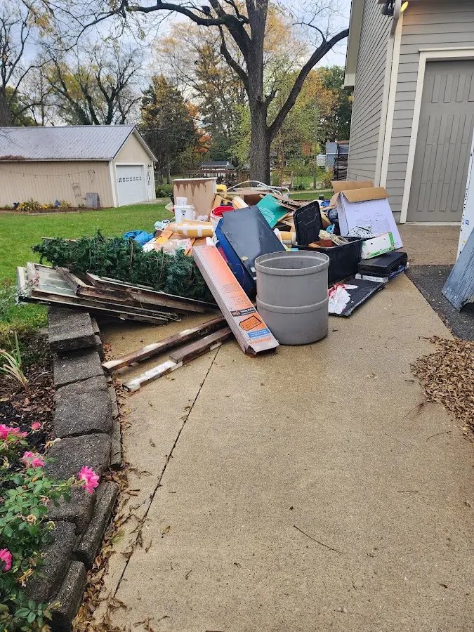 Dumpster being loaded with debris for Roofing Dumpster Rental in Kildeer